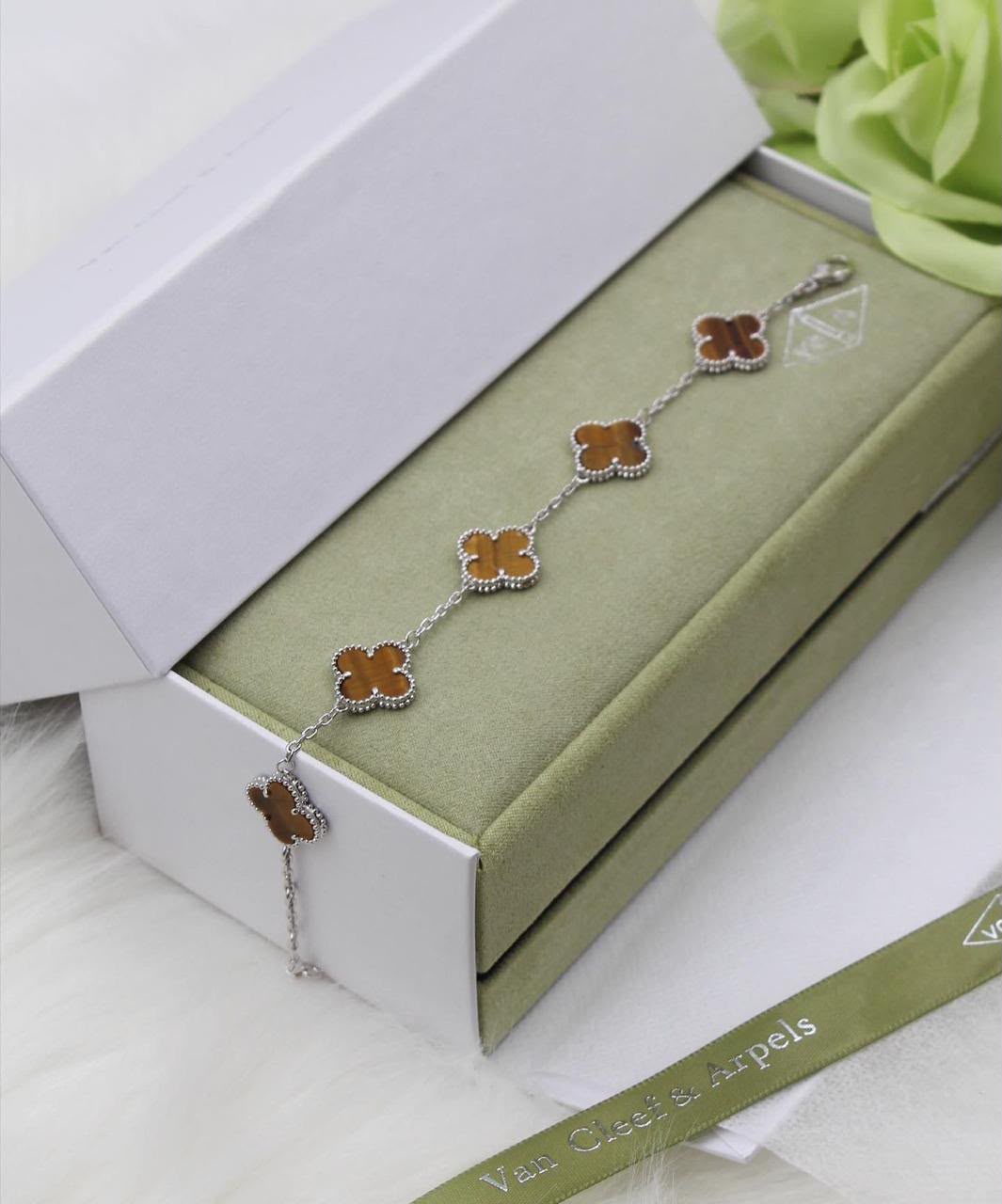 FAYZA clover charm bracelet in tiger's-eye stone presented in a sage gift box